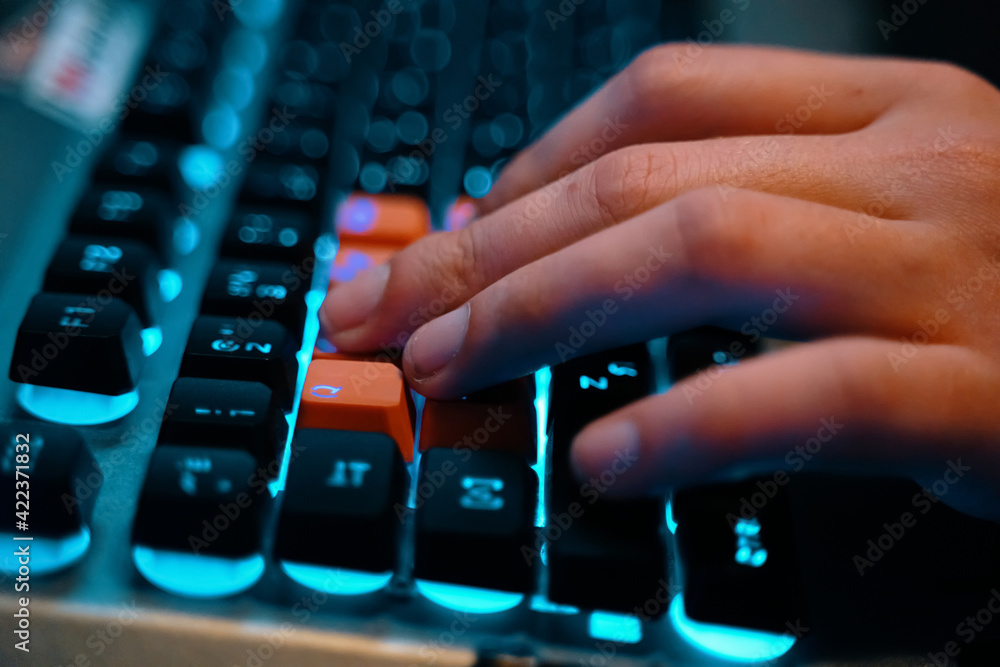 Multifunction keyboard with set of red keys and backlit. Employee uses a keyboard. WASD keys are used in many video games. Multifunction keyboard with set of red keys and backlit. Employee uses a keyboard. WASD keys are used in many video games.