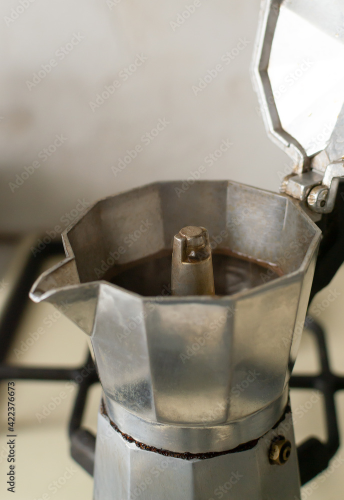 Geyser coffee maker on the stove. The concept of making morning coffee at home. Vertical orientation. Geyser coffee maker on the stove. The concept of making morning coffee at home. Vertical orientation.