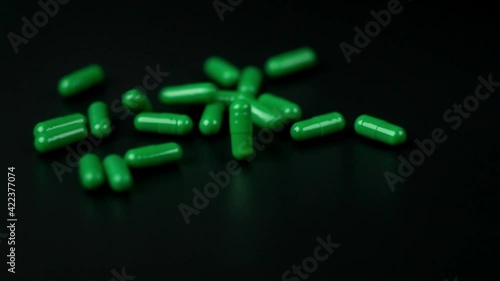 falling green pills capsule