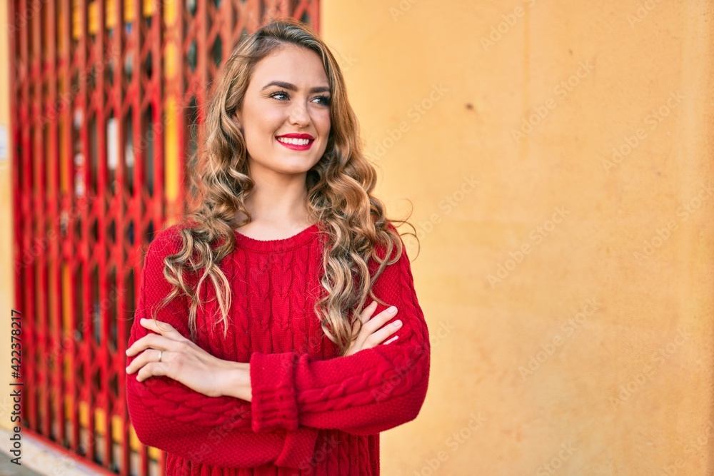 Fototapeta premium Young blonde girl smiling happy walking at the city.