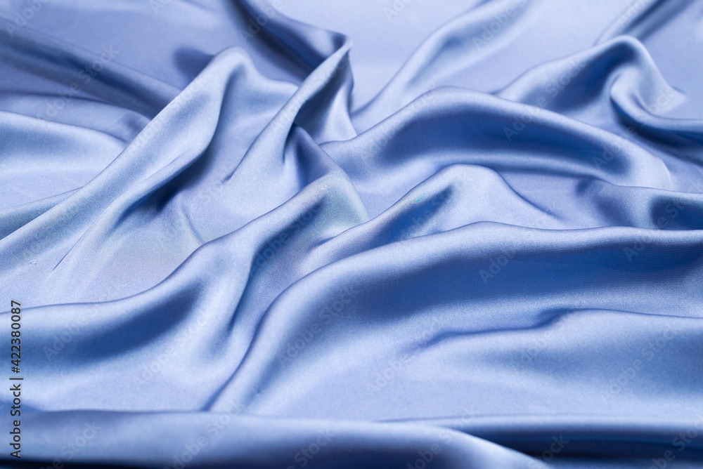 Obraz premium Blue silk or satin luxury fabric texture. Top view.