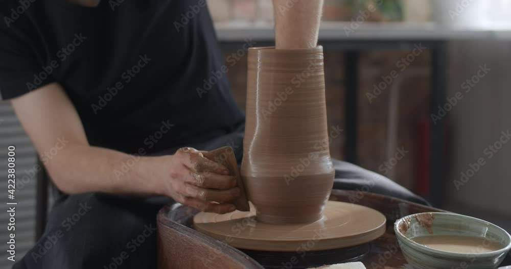 Potter shapes a jug in slow motion on a potter's wheel, video from pottery workshop, potter makes ceramics in slow motion, 4k 60p Prores HQ 10 bit Potter shapes a jug in slow motion on a potter's wheel, video from pottery workshop, potter makes ceramics in slow motion, 4k 60p Prores HQ 10 bit