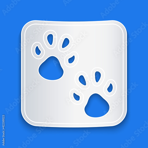 Paper cut Paw print icon isolated on blue background. Dog or cat paw print. Animal track. Paper art style. Vector