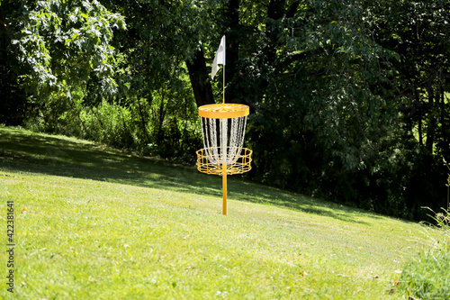 yellow disc golf basket with white flag