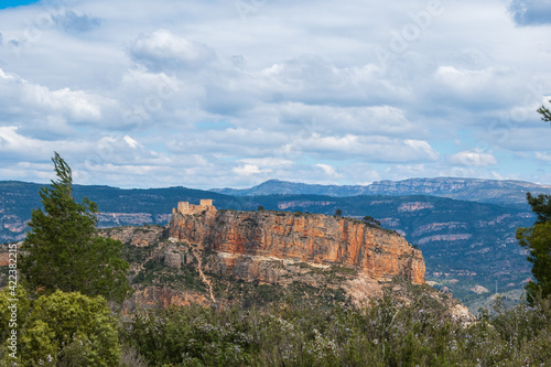 Natural environment of Cortes de pallás, in Valencia (Spain), with views of its mountains, Chirel Castle and its coniferous forests. On a sunny and cloudy day.