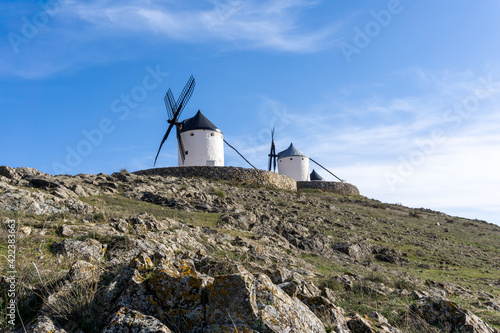 traditional whitewashed Spanish windmills in La Mancha on a hilltop above Consuegra