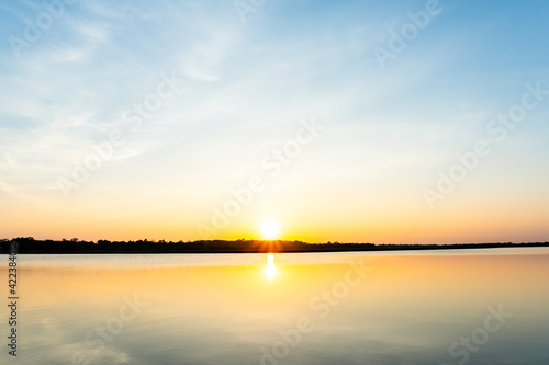 Sunset in the lake, beautiful sunset above the sea landscape background © Achira22