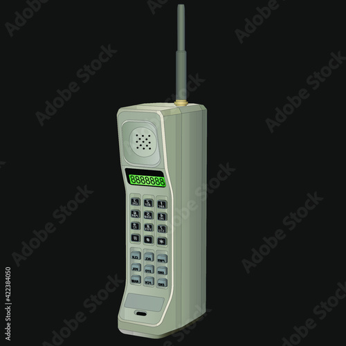 A big, old, gray cell phone with an antenna, gray buttons, and green numbers. One of the first wireless phones