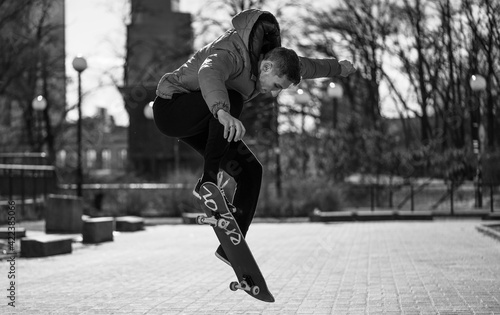 guy is racing on a skateboard down the street