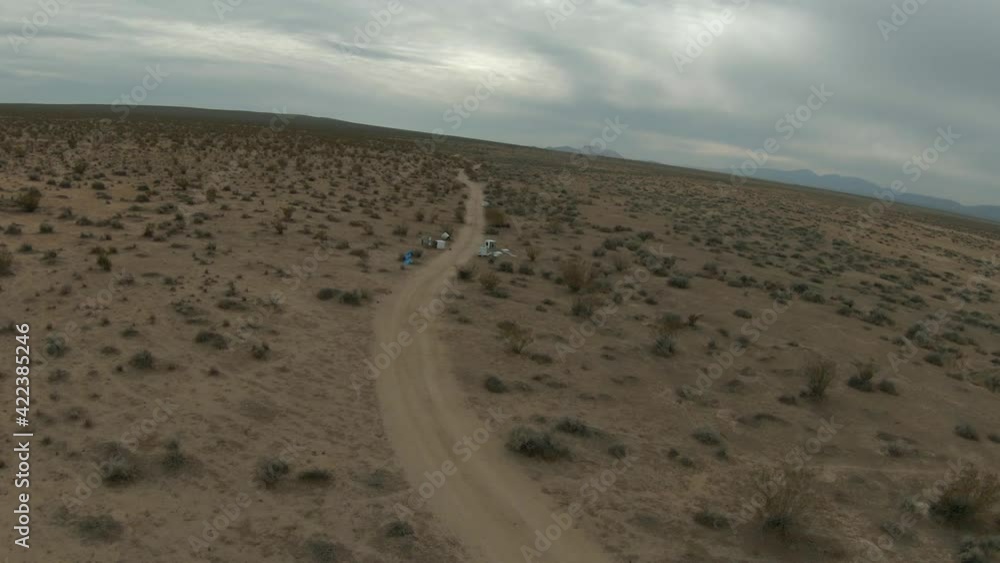 Flying over the desert to where unscrupulous people unlawfully dumped broken appliance and other trash along the road Flying over the desert to where unscrupulous people unlawfully dumped broken appliance and other trash along the road