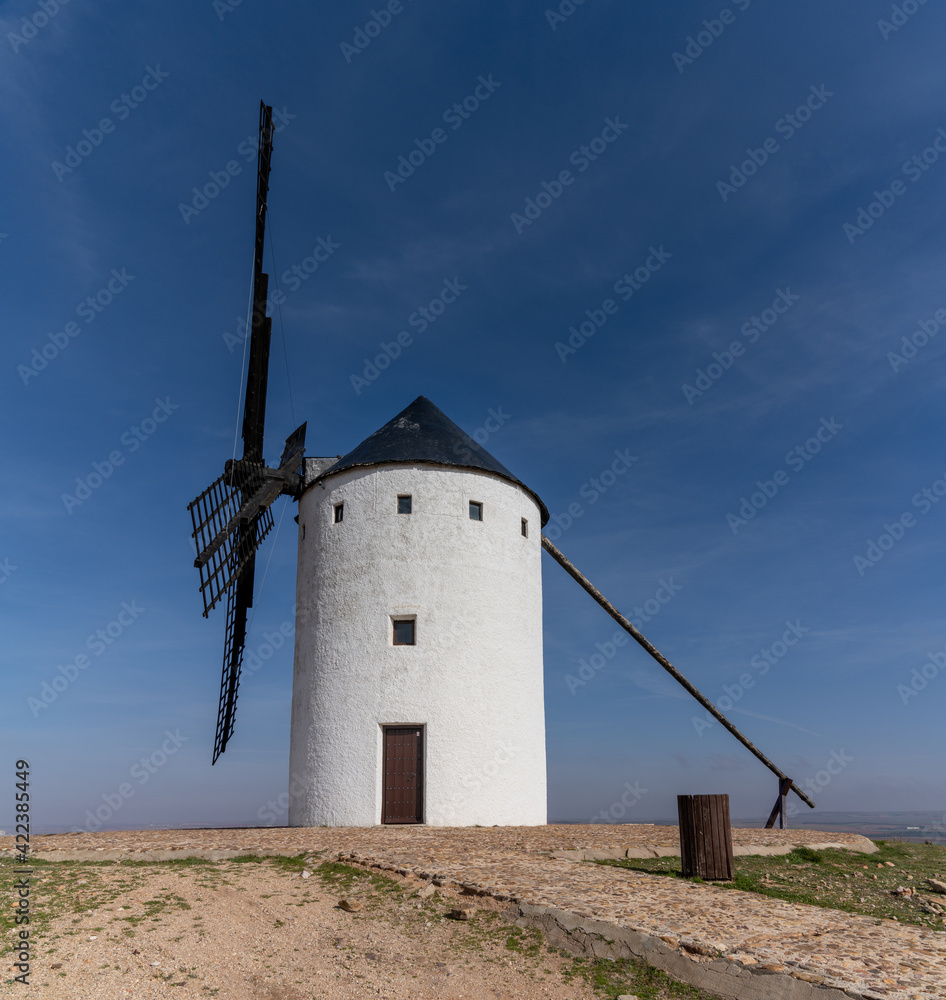 whitewashed historic windmill typical of the La Mancha region of central Spain under a blue sky whitewashed historic windmill typical of the La Mancha region of central Spain under a blue sky