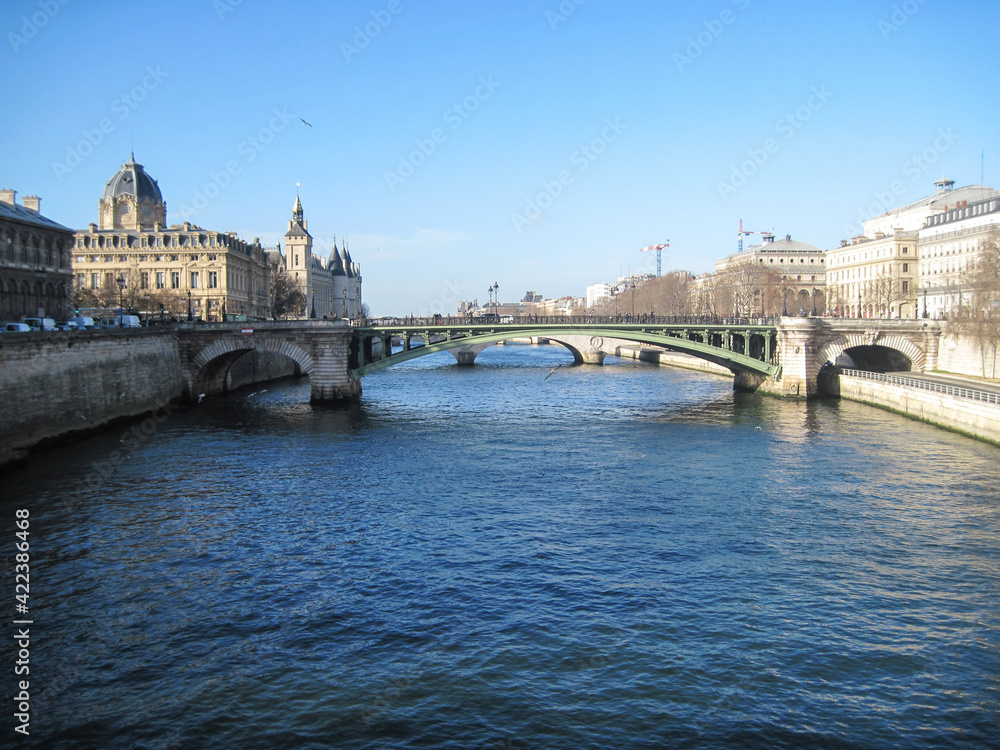 Beautiful city landscape with bridge over the Seine River on a cold spring day.