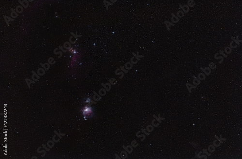 Winter night sky with purple Orion nebula many spiked stars visible photo