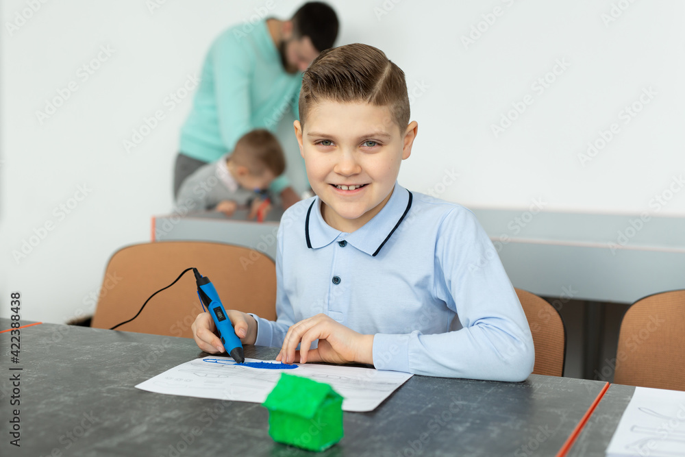 Child using 3D printing pen. Boy making new item. Creative, technology, leisure, education concept