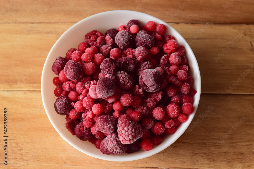 white bowl with a frozen red berries white bowl with a frozen red berries