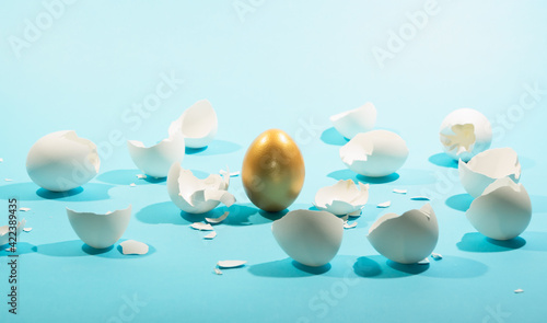 Fotografie, Obraz Intact golden egg among broken white eggs