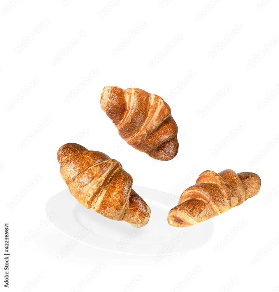 Levitation of three croissants on a white plate and white background. Levitation of three croissants on a white plate and white background.