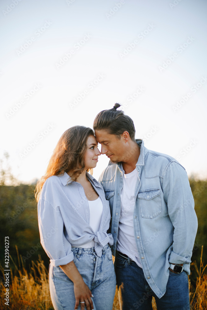 happy young couple in the park at sunset. man and woman gently touch their noses and foreheads. couple in love hugging outdoors.
happy young couple in the park at sunset. man and woman gently touch their noses and foreheads. couple in love hugging outdoors.