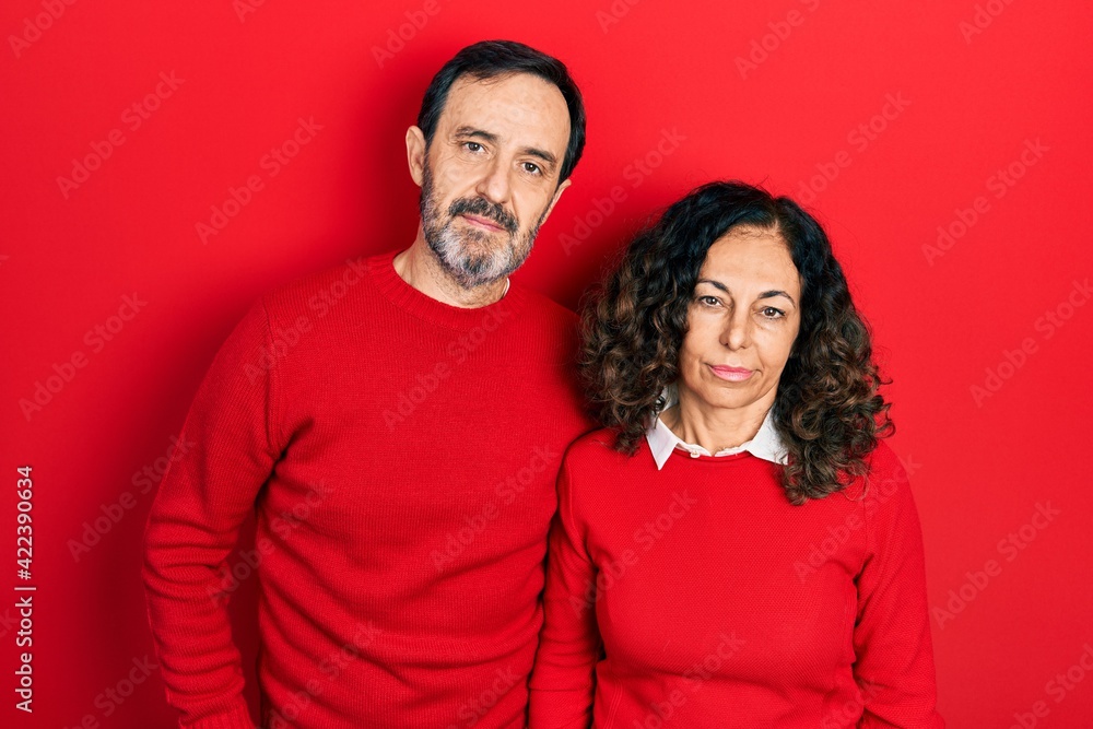 Middle age couple of hispanic woman and man hugging and standing together looking sleepy and tired, exhausted for fatigue and hangover, lazy eyes in the morning. Middle age couple of hispanic woman and man hugging and standing together looking sleepy and tired, exhausted for fatigue and hangover, lazy eyes in the morning.