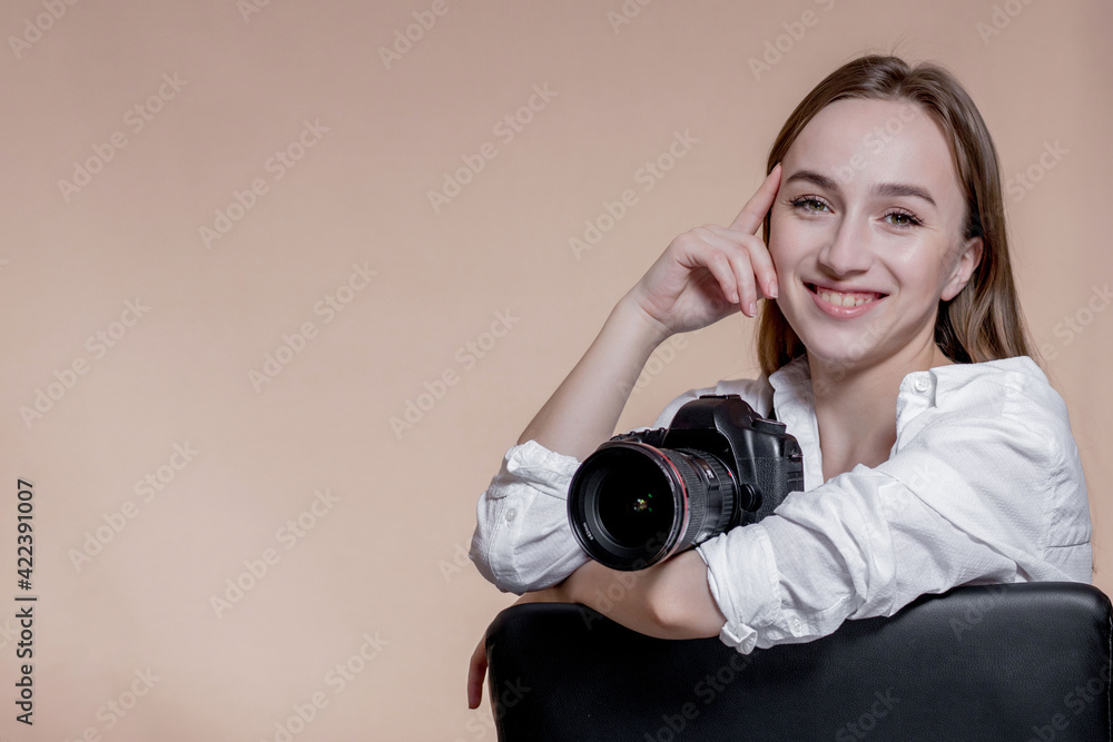 Close up portrait of woman photographer with camera taking pictures with digital camera on brown background