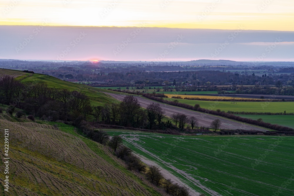 a scenic landscape view across Pewsey Vale and Pewsey Village in Wiltshire, North Wessex Downs AONB