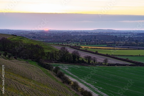 a scenic landscape view across Pewsey Vale and Pewsey Village in Wiltshire, North Wessex Downs AONB
