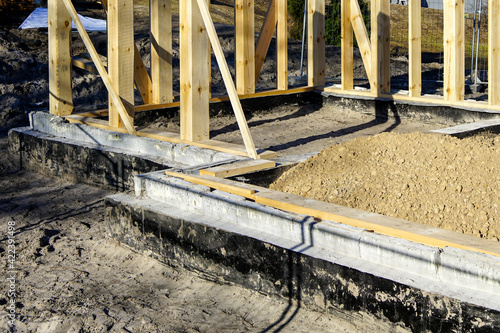 new wooden house frame concrete foundation waterproofing and damp proofing with bitumen membrane photo