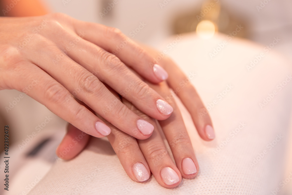 manicurist holds hands of the client in beauty salon. manicure in the salon