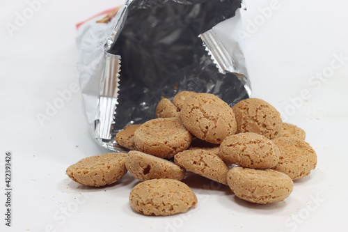 Closeup shhot of an opened bag of amaretti biscuits isolated on white background photo