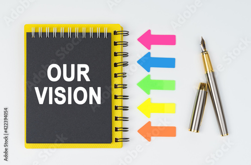 Wallpaper Mural On a white background lies a pen, arrows and a notebook with the inscription - OUR VISION Torontodigital.ca