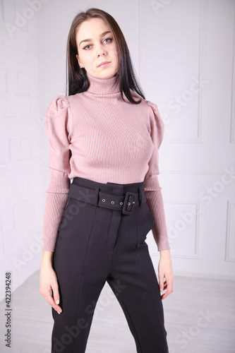Young beautiful girl show clothes for an online store. Bright clothes.