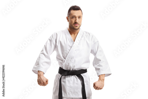 Young man in karate kimono with black belt