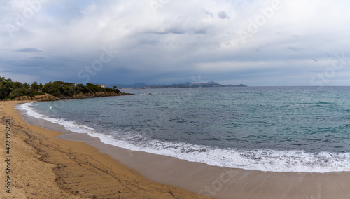 golden sand beach on the French Riviera under an expressive overcast sky