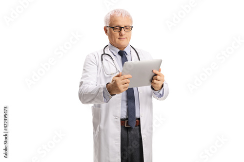 Mature doctor holding a digital tablet
