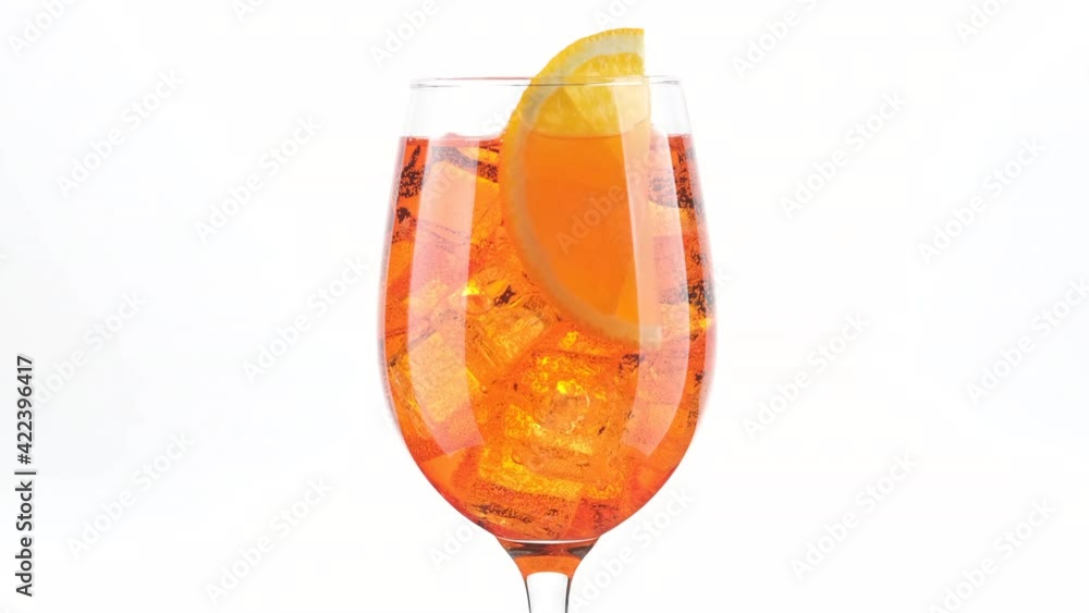 Aperol Spritz Cocktail with ice isolated on white background, rotation. glass of Summer orange cocktail Aperol Spritz Cocktail with ice isolated on white background, rotation. glass of Summer orange cocktail