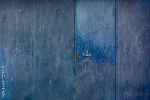 Metal of a metal door, weathered in southern Spain