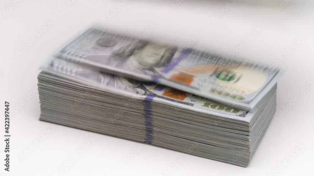 Wind blows or blowing 100 hundred dollars banknotes off the table. Bank financial concept Wind blows or blowing 100 hundred dollars banknotes off the table. Bank financial concept