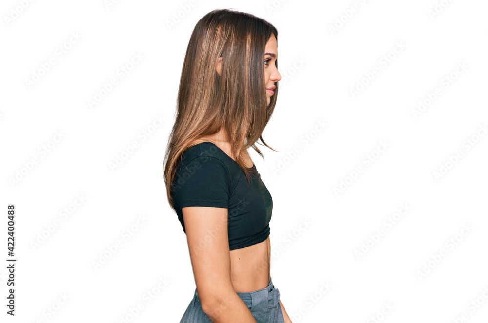 Young brunette woman wearing casual clothes looking to side, relax profile pose with natural face with confident smile. Young brunette woman wearing casual clothes looking to side, relax profile pose with natural face with confident smile.