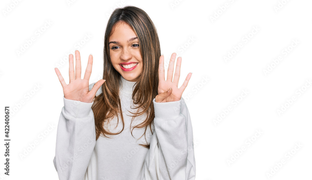 Young brunette woman wearing casual turtleneck sweater showing and pointing up with fingers number nine while smiling confident and happy. Young brunette woman wearing casual turtleneck sweater showing and pointing up with fingers number nine while smiling confident and happy.