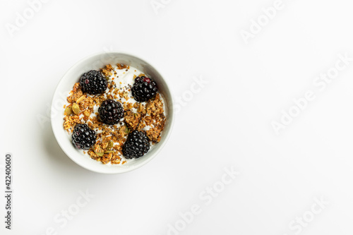 Yogurt with granola and blackberries