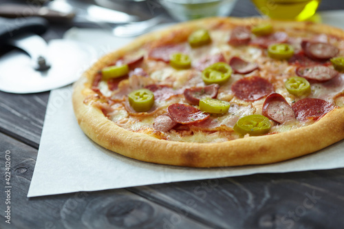 tasty pizza on the wooden background