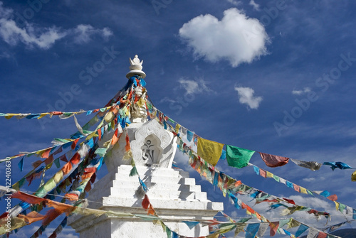 Tibetan stupa with prayer flags in Shangri-la, Yunnan Province, China photo