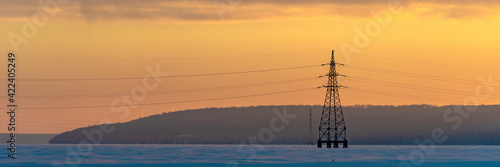 Industrial high voltage electricity tower with sky sunrise. Wide banner