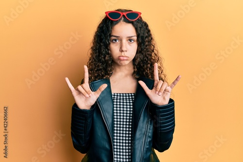 Teenager hispanic girl doing rock gesture depressed and worry for distress  crying angry and afraid. sad expression.