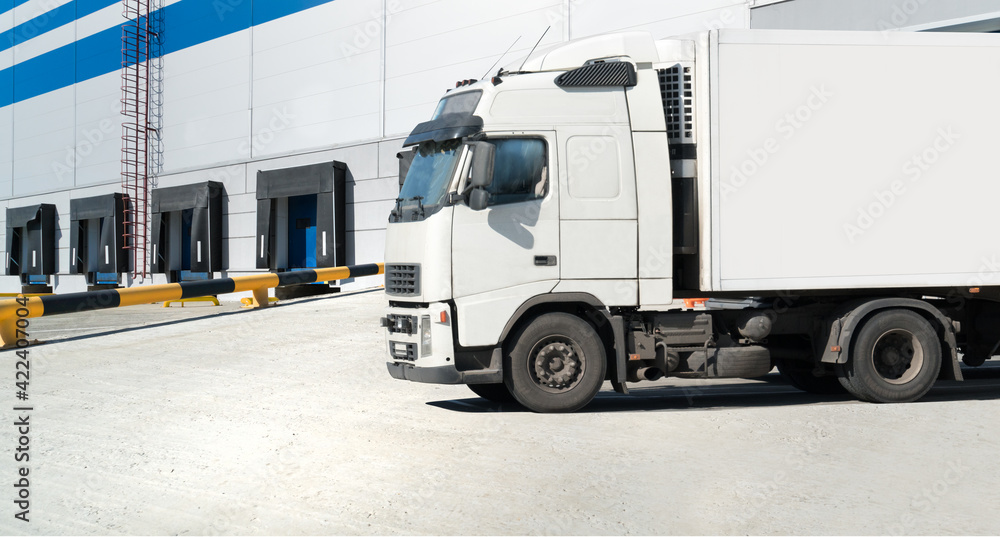 Big distribution warehouse with gates for loads and truck Big distribution warehouse with gates for loads and truck