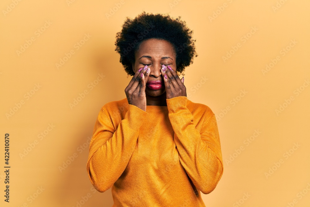 Young african american woman wearing casual clothes rubbing eyes for fatigue and headache, sleepy and tired expression. vision problem Young african american woman wearing casual clothes rubbing eyes for fatigue and headache, sleepy and tired expression. vision problem