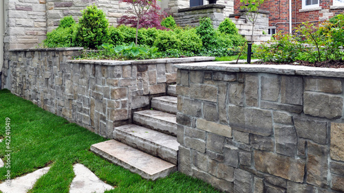 Natural stone steps and retaining wall in the garden. photo