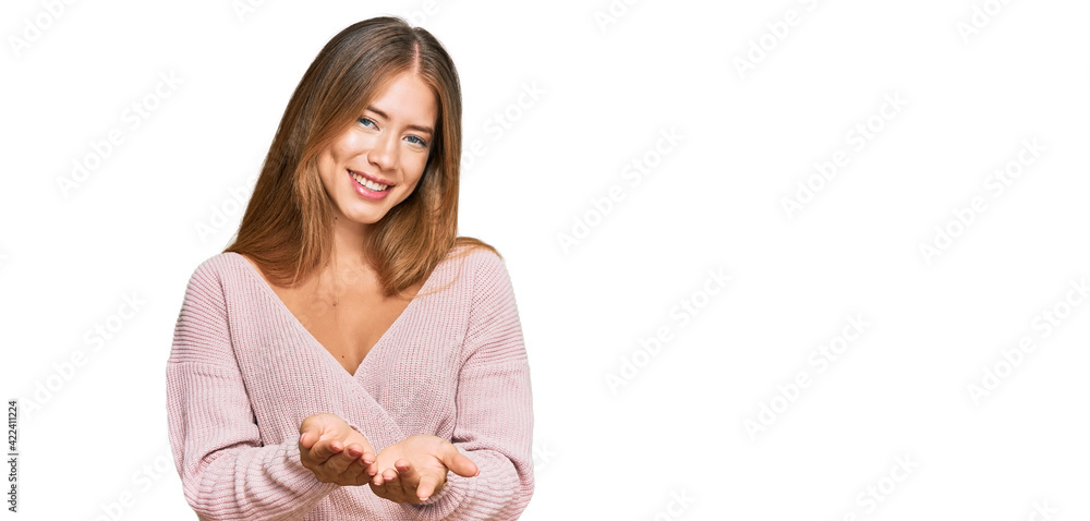 Beautiful blonde woman wearing casual winter pink sweater smiling with hands palms together receiving or giving gesture. hold and protection Beautiful blonde woman wearing casual winter pink sweater smiling with hands palms together receiving or giving gesture. hold and protection
