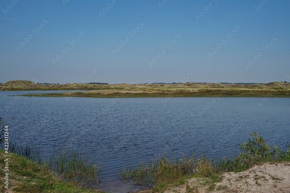 lake Taneso, Borsmose, Vejers, Jutland, Denmark on sunny day with blue sky lake Taneso, Borsmose, Vejers, Jutland, Denmark on sunny day with blue sky