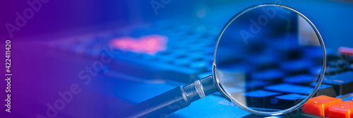 magnifying lens on the laptop keyboard in blue light